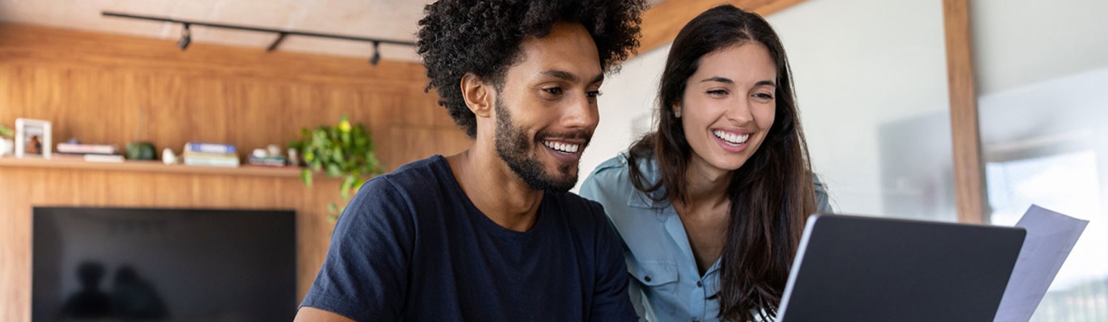 a couple looking at their laptop