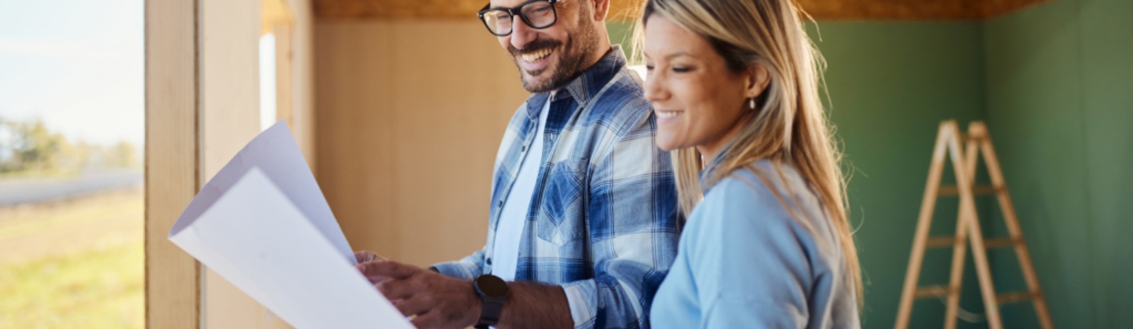 a couple looking at home remodeling blueprints