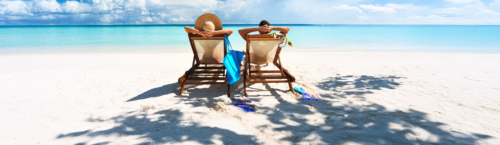 couple sitting in beach chairs at the beach