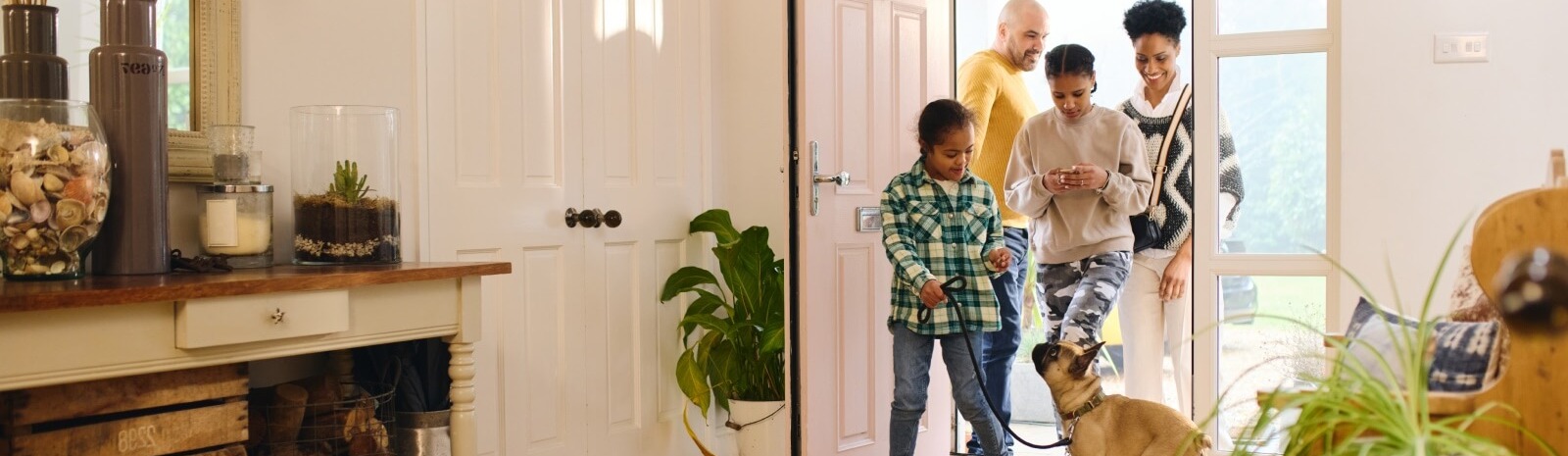 a family and dog walking in their house