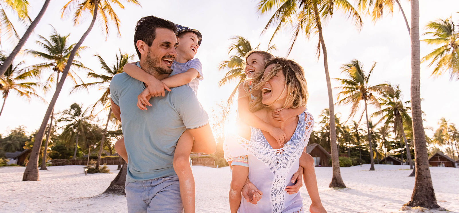 a family of four walking on a beach