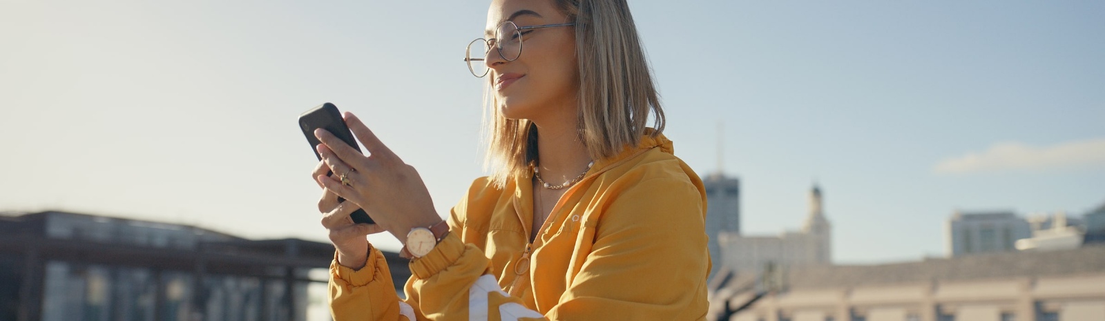 girl wearing eye glasses on her mobil phone