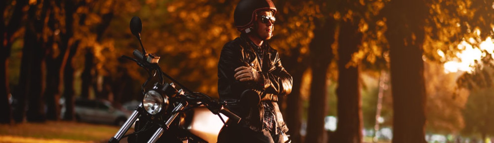 a person standing next to their motorcycle